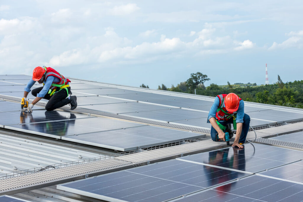 Personas instalando placas solares gracias al plan ecovivienda